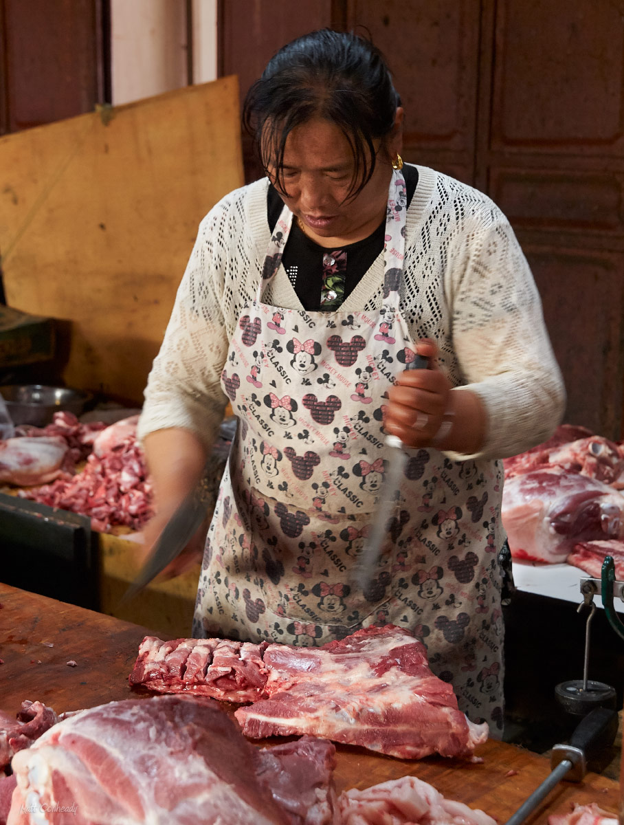 woman butcher chopping meat