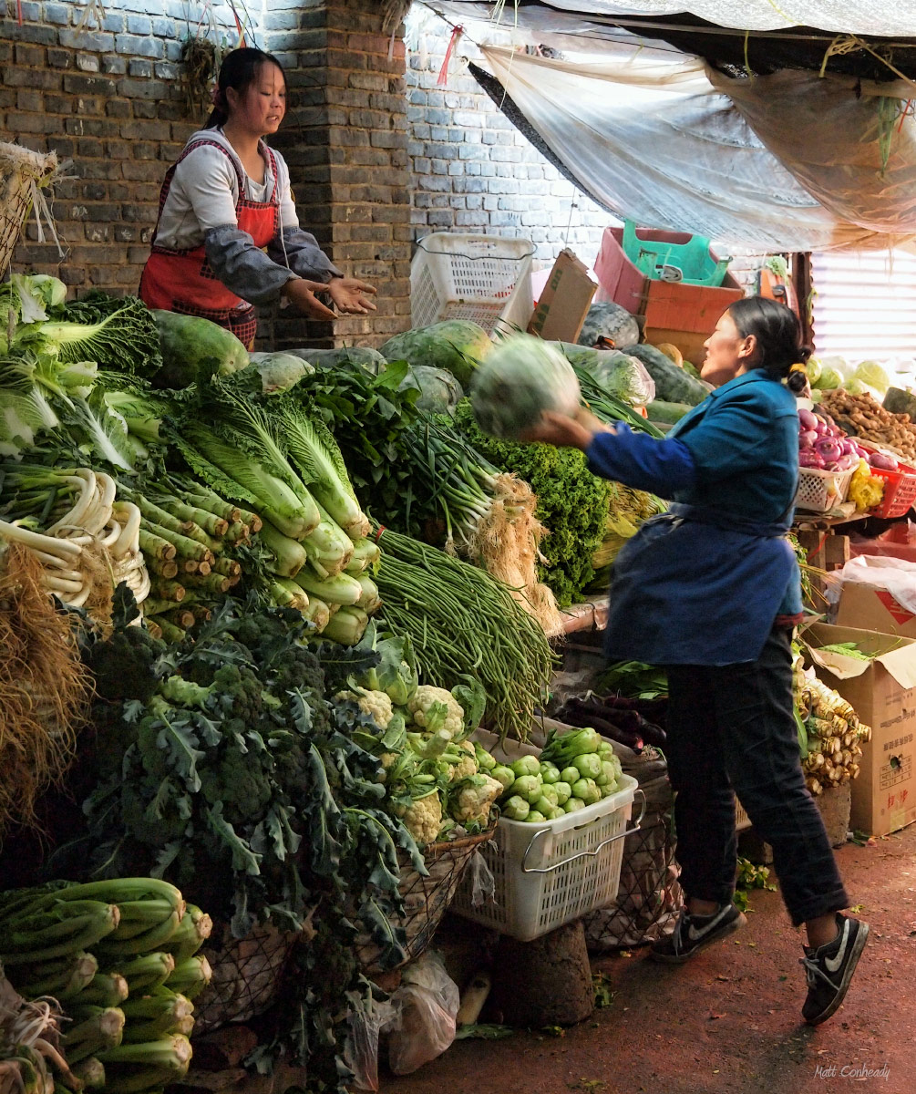 vegetable vendors tossing mellons