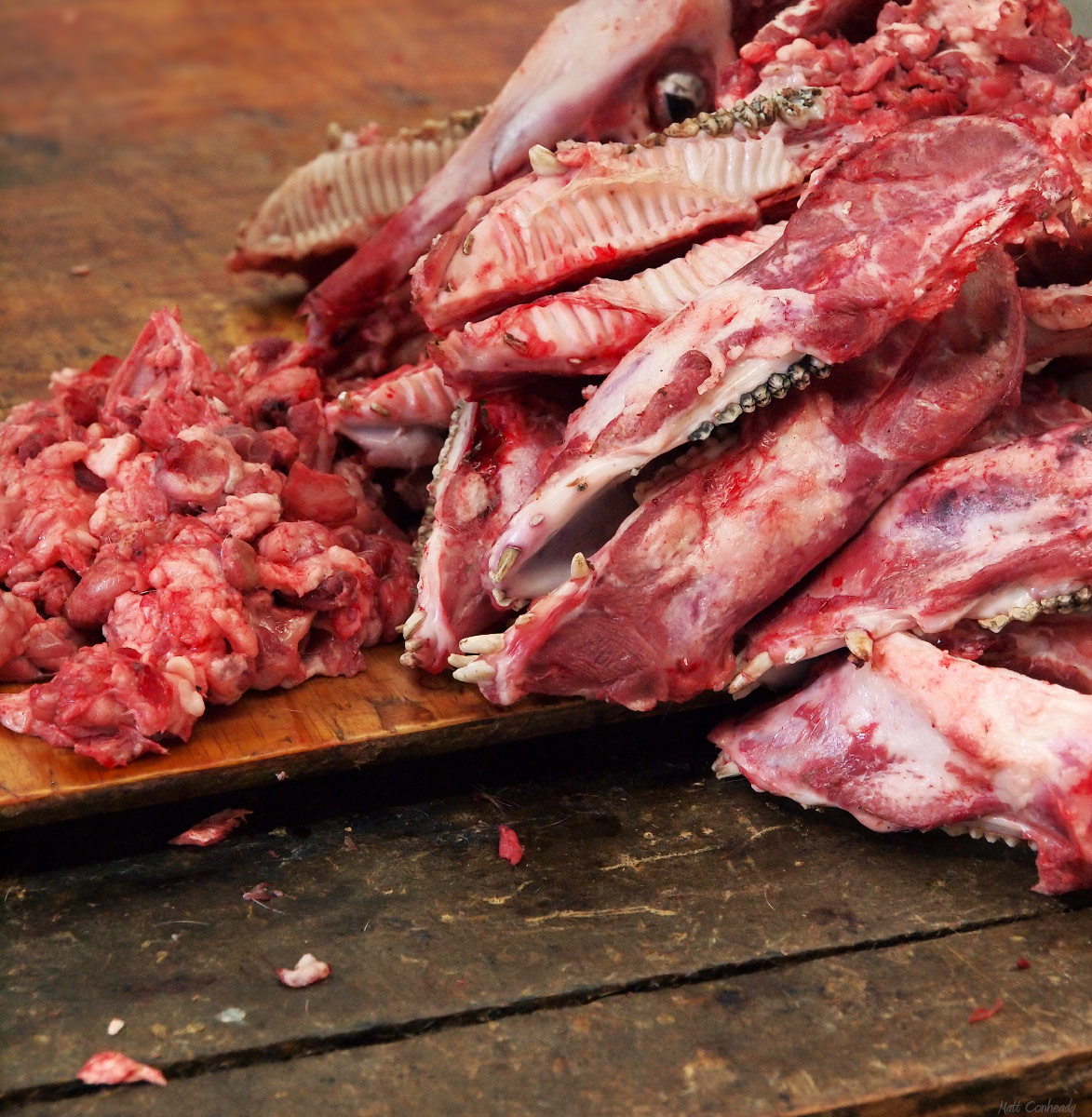 pork skulls and face meat on a table at a chinese meat market