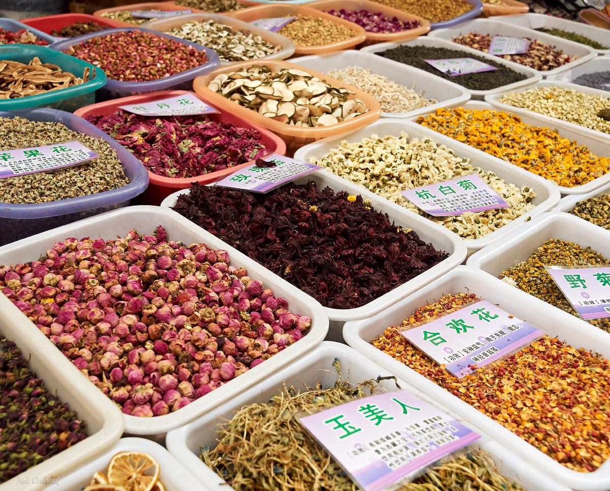 chinese spices on display in bins at the open air market in lijiang