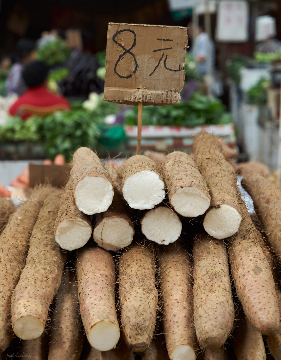 tubers for sale at an open air market in chengdu, china