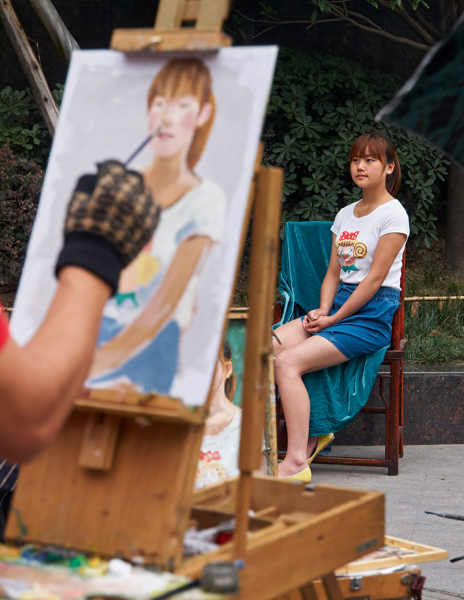 apainting being done of a girl on the streets of chengdu, china