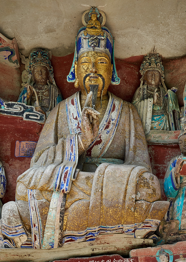 Painted stone carving with a gold face