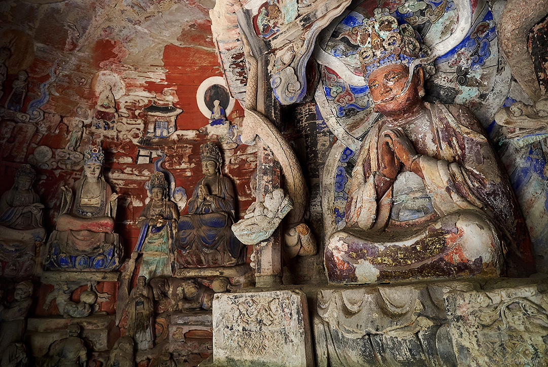 painted stone carvings showing buddhist scenes